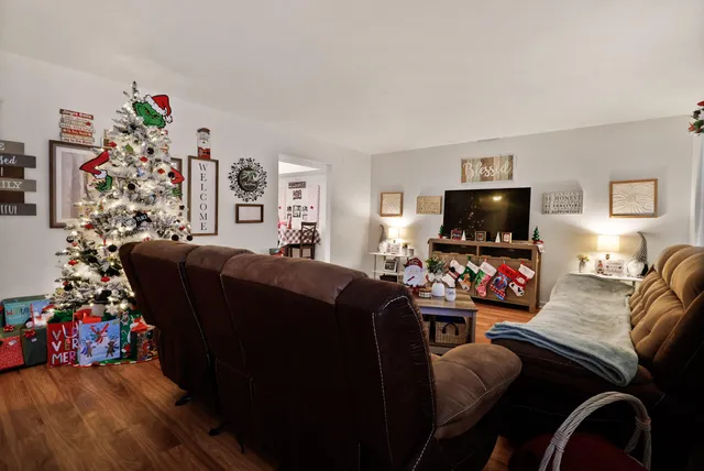 a bedroom with furniture and a flat screen tv