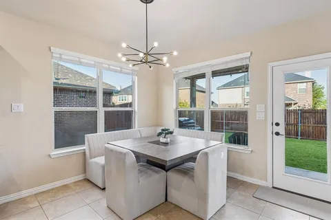 a view of a dining room with furniture wooden floor and a chandelier