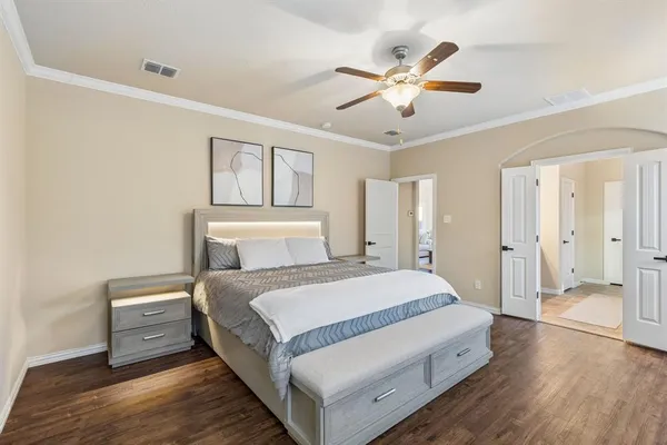 a bed room with a bed and a ceiling fan