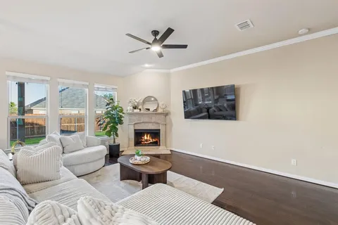 a living room with furniture and a fireplace