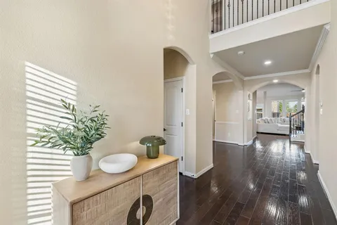 a view of a hallway that has two mirrors and a potted plant