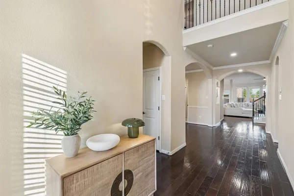 a view of a hallway that has two mirrors and a potted plant