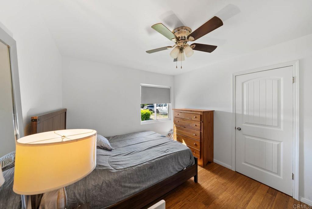565 June Way El Cajon, CA 92021 - Photo 17 of 42 a bedroom with a bed and a chandelier