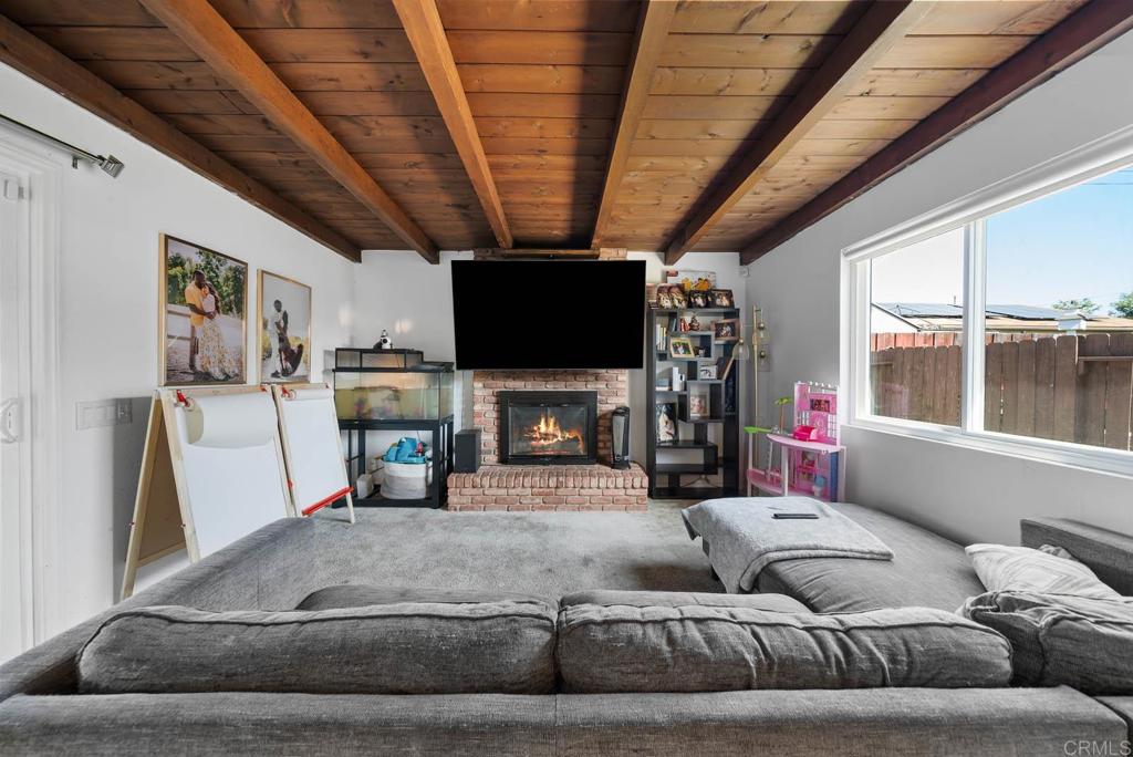 565 June Way El Cajon, CA 92021 - Photo 2 of 42 a living room with furniture a fireplace and a flat screen tv