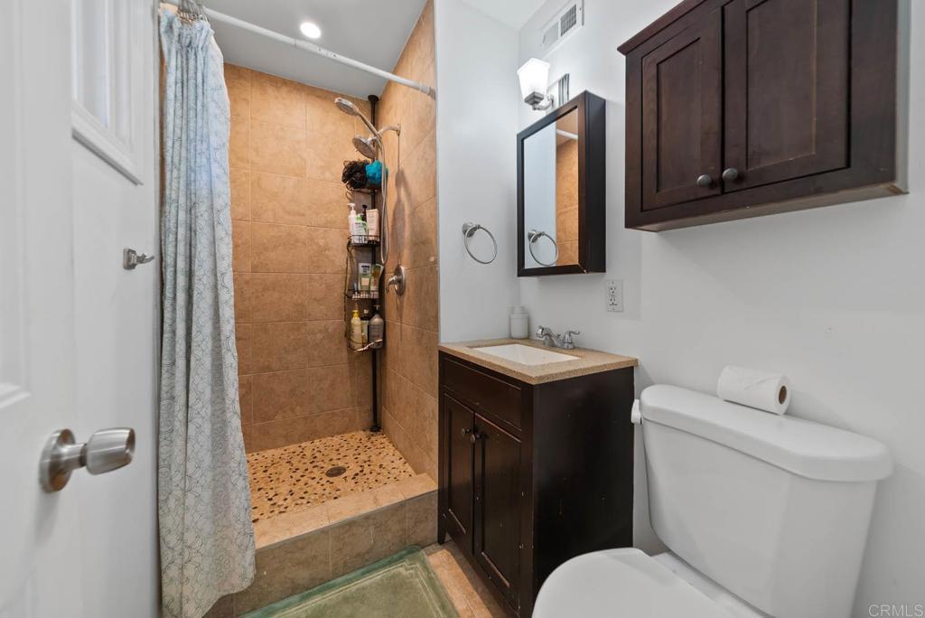 565 June Way El Cajon, CA 92021 - Photo 27 of 42 a bathroom with a sink toilet and shower