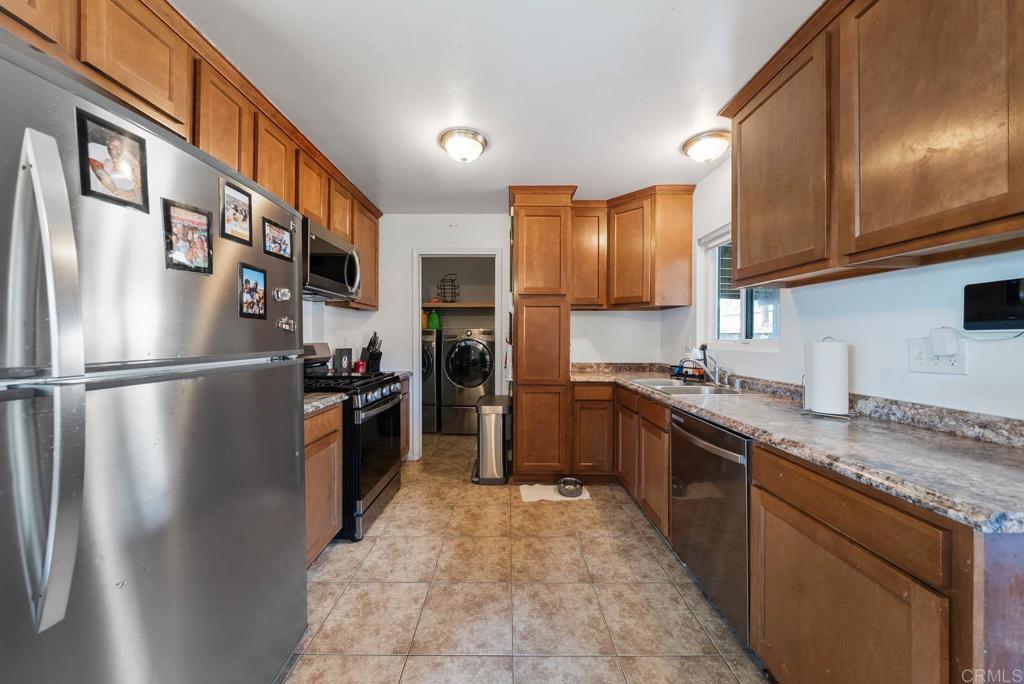 565 June Way El Cajon, CA 92021 - Photo 8 of 42 a kitchen with stainless steel appliances granite countertop a refrigerator a sink dishwasher a stove and a refrigerator