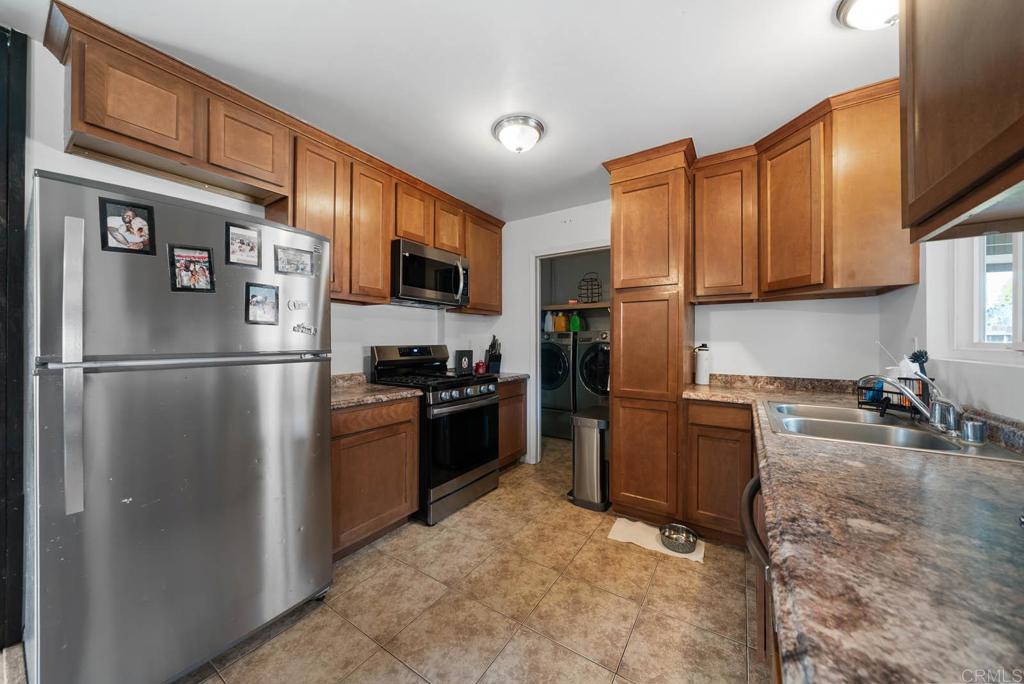 565 June Way El Cajon, CA 92021 - Photo 9 of 42 a kitchen with stainless steel appliances granite countertop a refrigerator stove top oven a sink and dishwasher