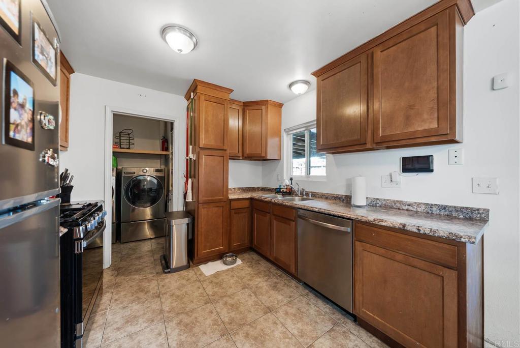 565 June Way El Cajon, CA 92021 - Photo 10 of 42 a kitchen with a sink stove and refrigerator
