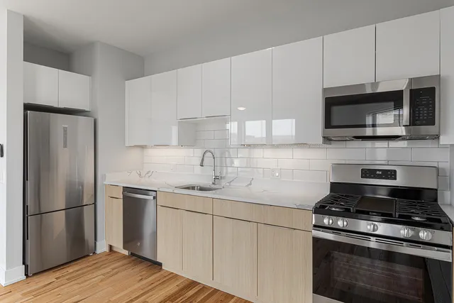 a kitchen with a sink stove and refrigerator