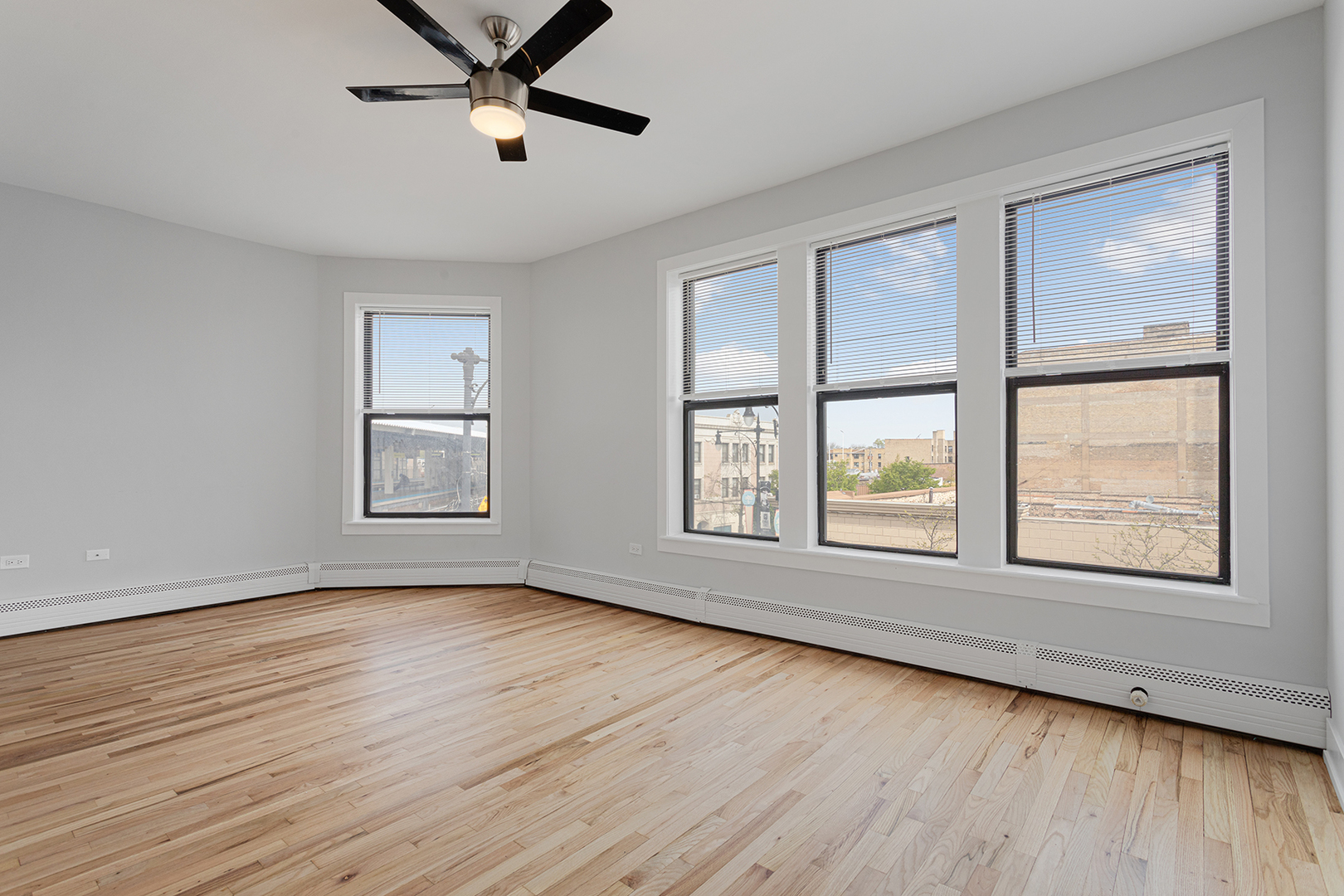 1625 West Howard Street, Unit 219 Chicago, IL 60626 - Photo 3 of 10 a view of an empty room with wooden floor and a window