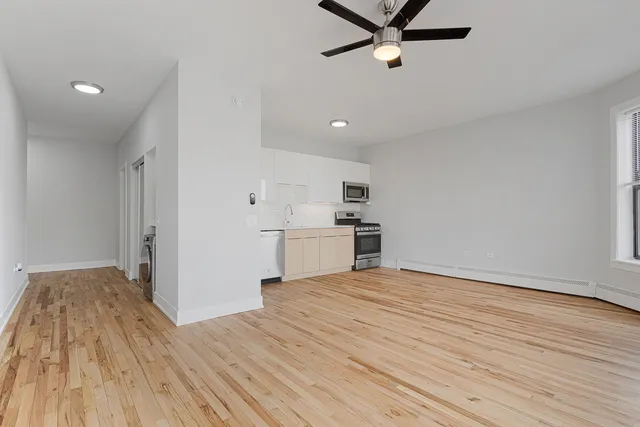 a view of a kitchen with wooden floor and a sink
