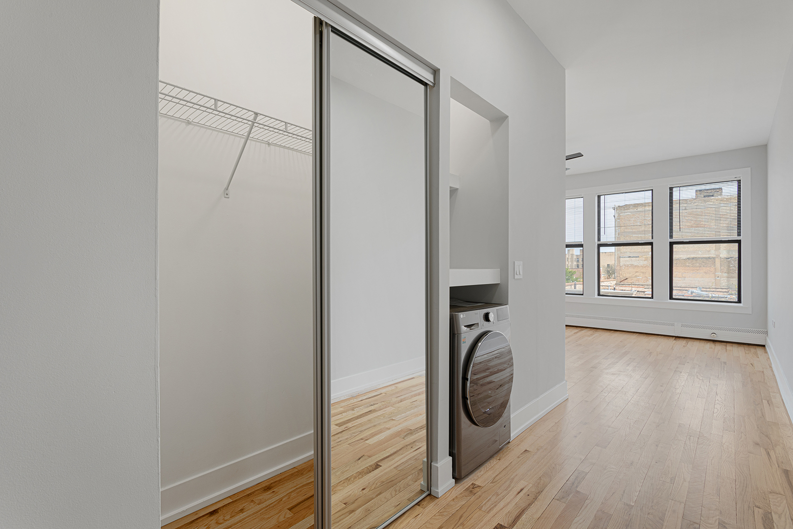 1625 West Howard Street, Unit 219 Chicago, IL 60626 - Photo 6 of 10 a view of a hallway with wooden floor and entryway