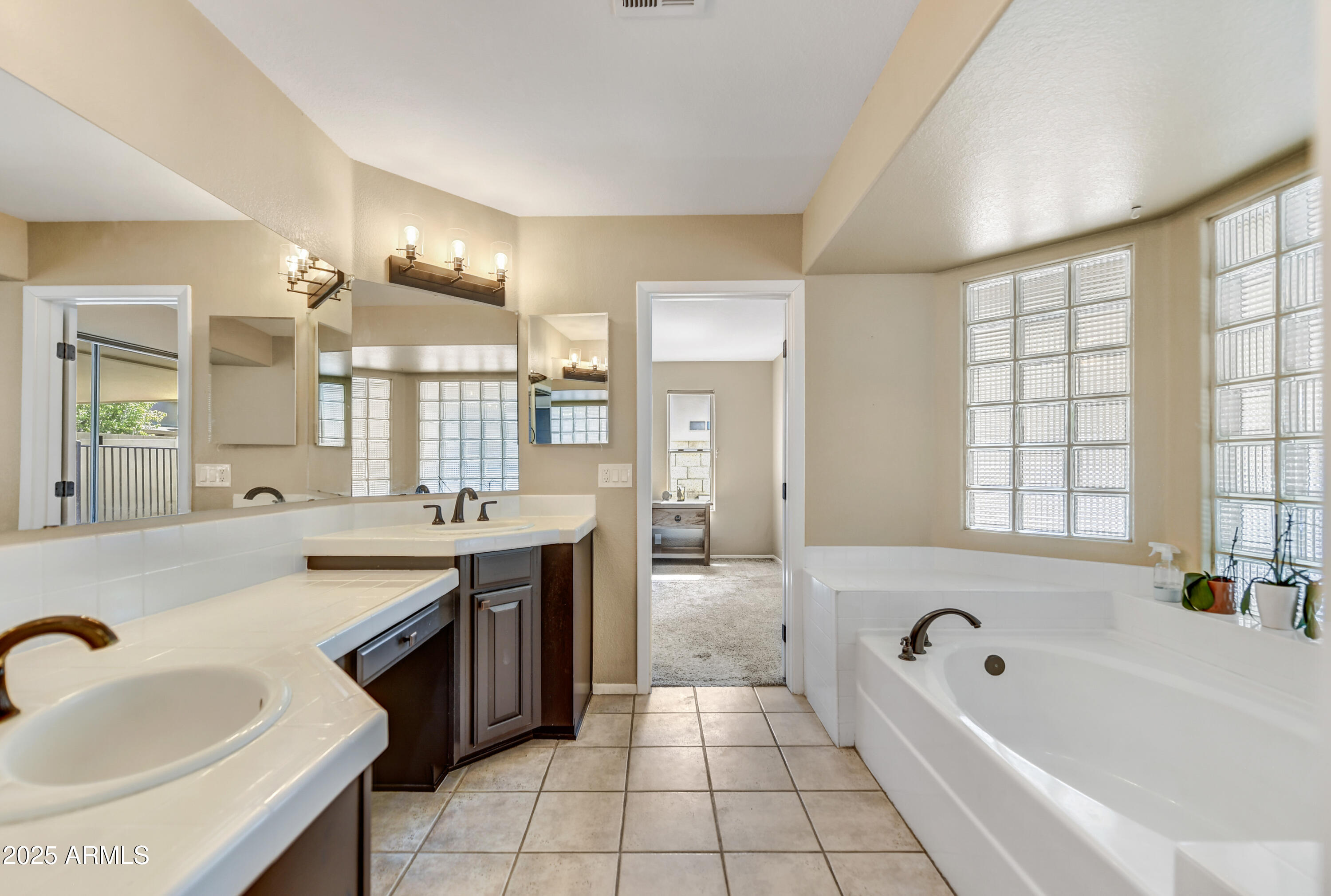 2015 East Bendix Drive Tempe, AZ 85283 - Photo 14 of 31 a spacious bathroom with a tub sink and mirror