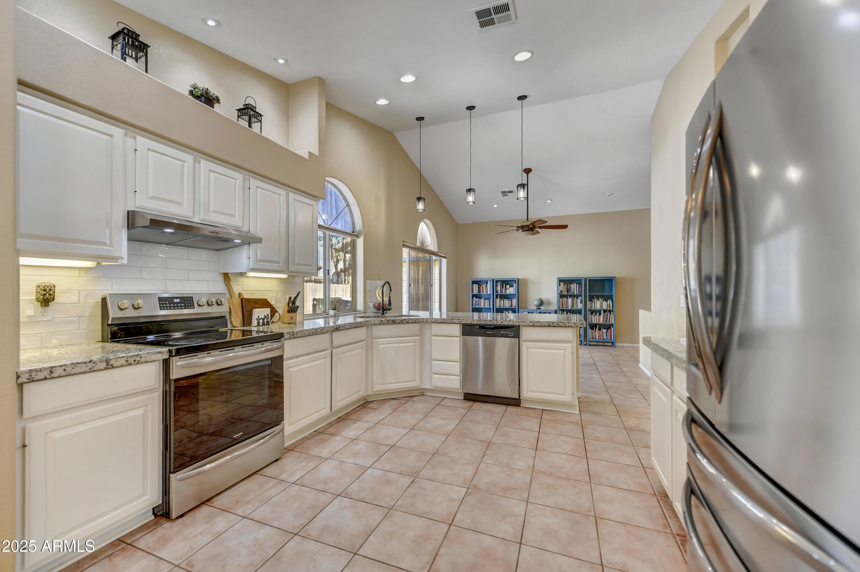 2015 East Bendix Drive Tempe, AZ 85283 - Photo 10 of 31 a white kitchen with stainless steel appliances granite countertop a stove a sink dishwasher and a refrigerator