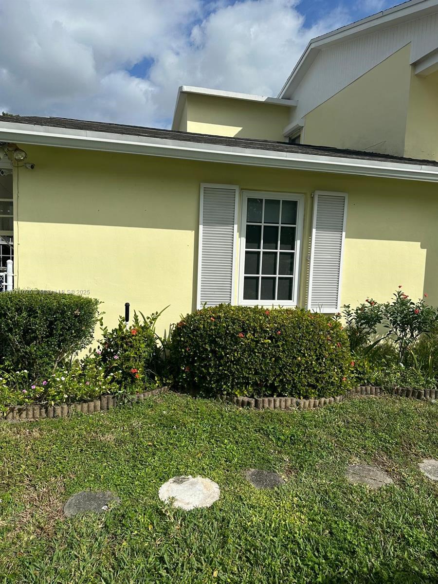9101 Southwest 88th Street, Unit 1 Miami, FL 33173 - Photo 1 of 10 a view of a house with a garden and a yard