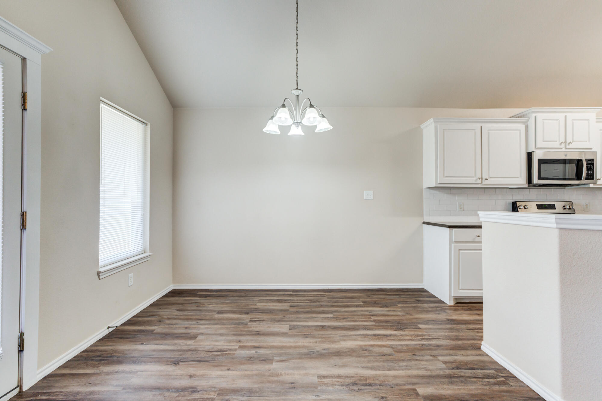 7518 87th Street Lubbock, TX 79424 - Photo 11 of 36 a view of a kitchen with microwave and cabinets