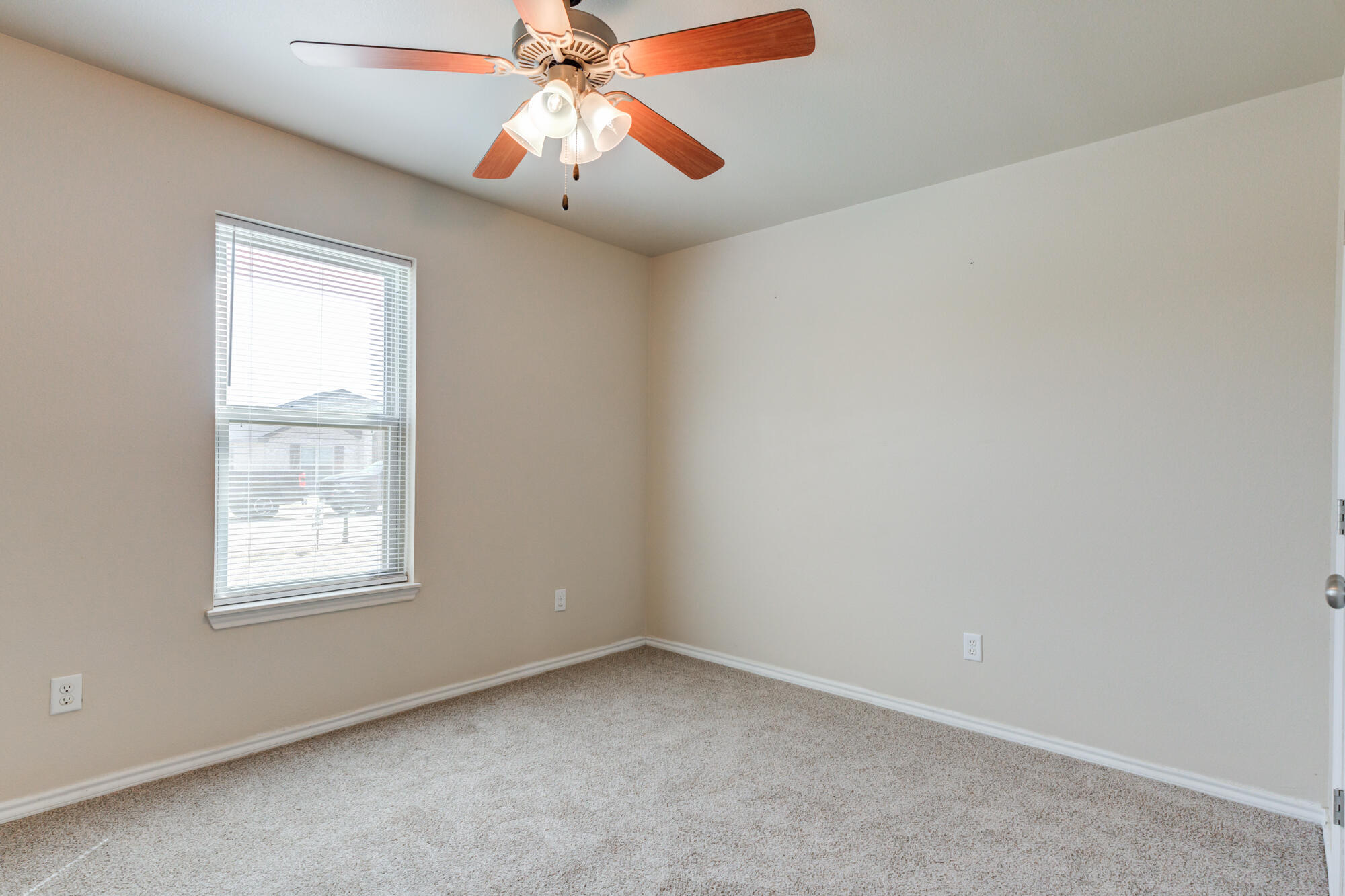 7518 87th Street Lubbock, TX 79424 - Photo 20 of 36 an empty room with windows and fan