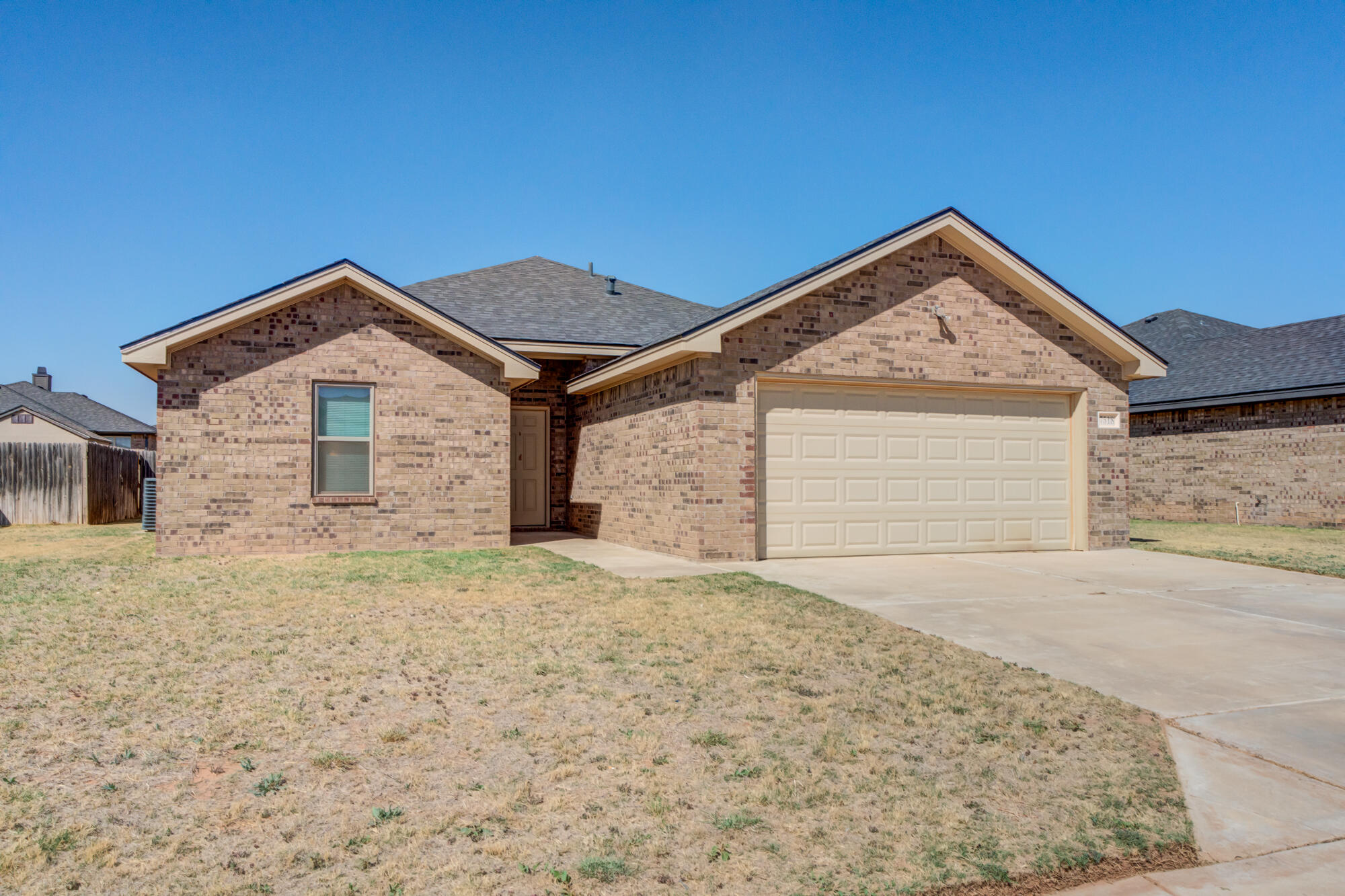 7518 87th Street Lubbock, TX 79424 - Photo 2 of 36 a front view of a house with a yard and garage