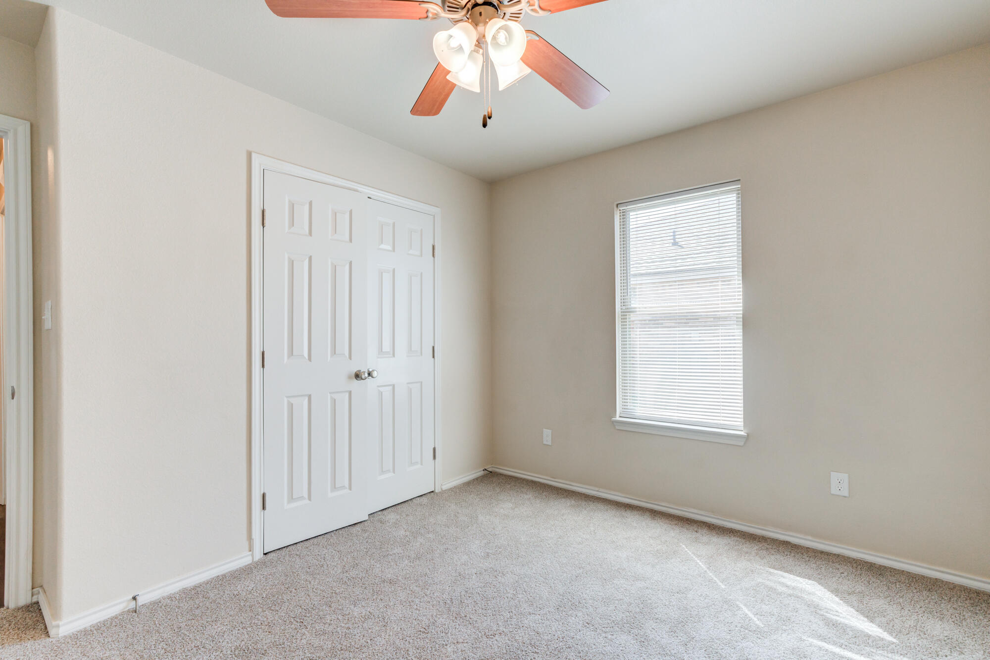 7518 87th Street Lubbock, TX 79424 - Photo 24 of 36 an empty room with window and chandelier fan