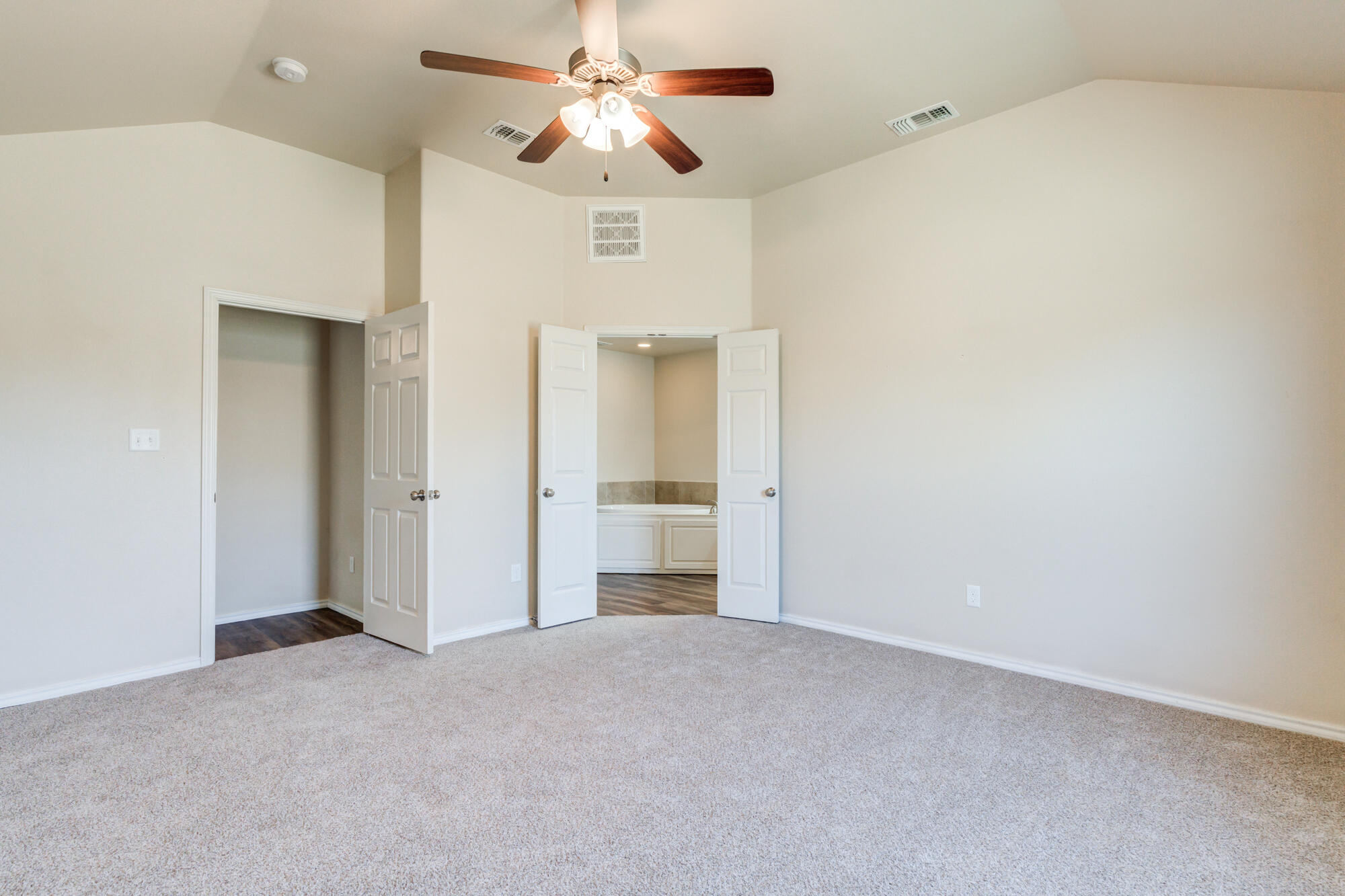 7518 87th Street Lubbock, TX 79424 - Photo 27 of 36 an empty room with a ceiling fan and a bathroom