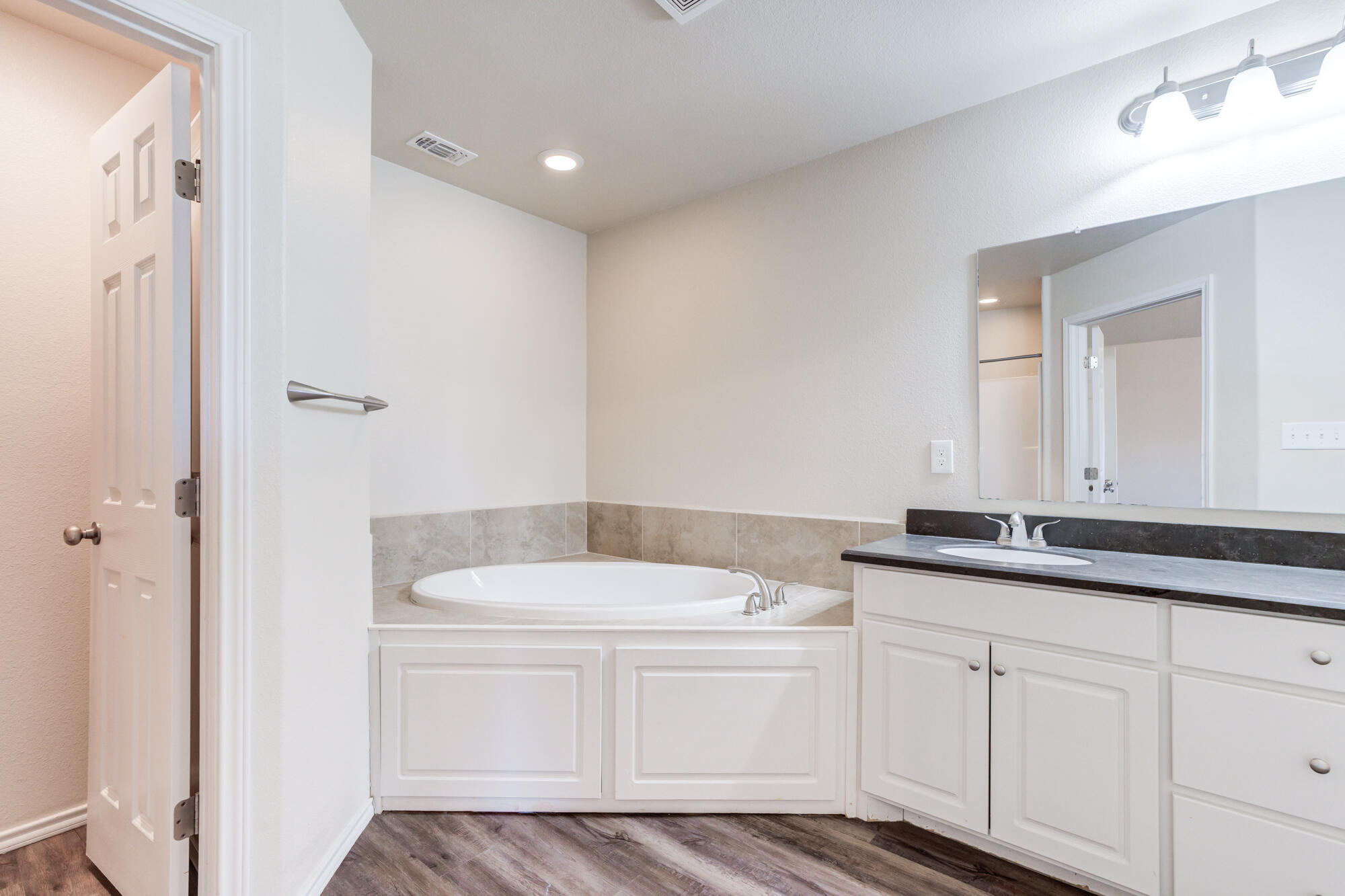 7518 87th Street Lubbock, TX 79424 - Photo 28 of 36 a bathroom with a sink and a mirror