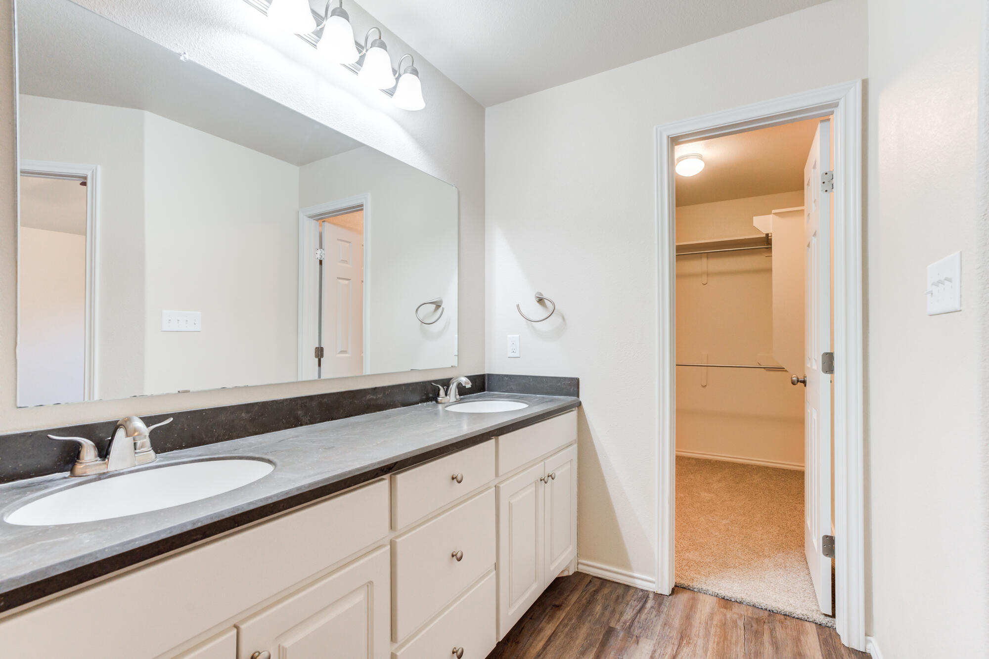 7518 87th Street Lubbock, TX 79424 - Photo 30 of 36 a bathroom with a granite countertop sink and a mirror