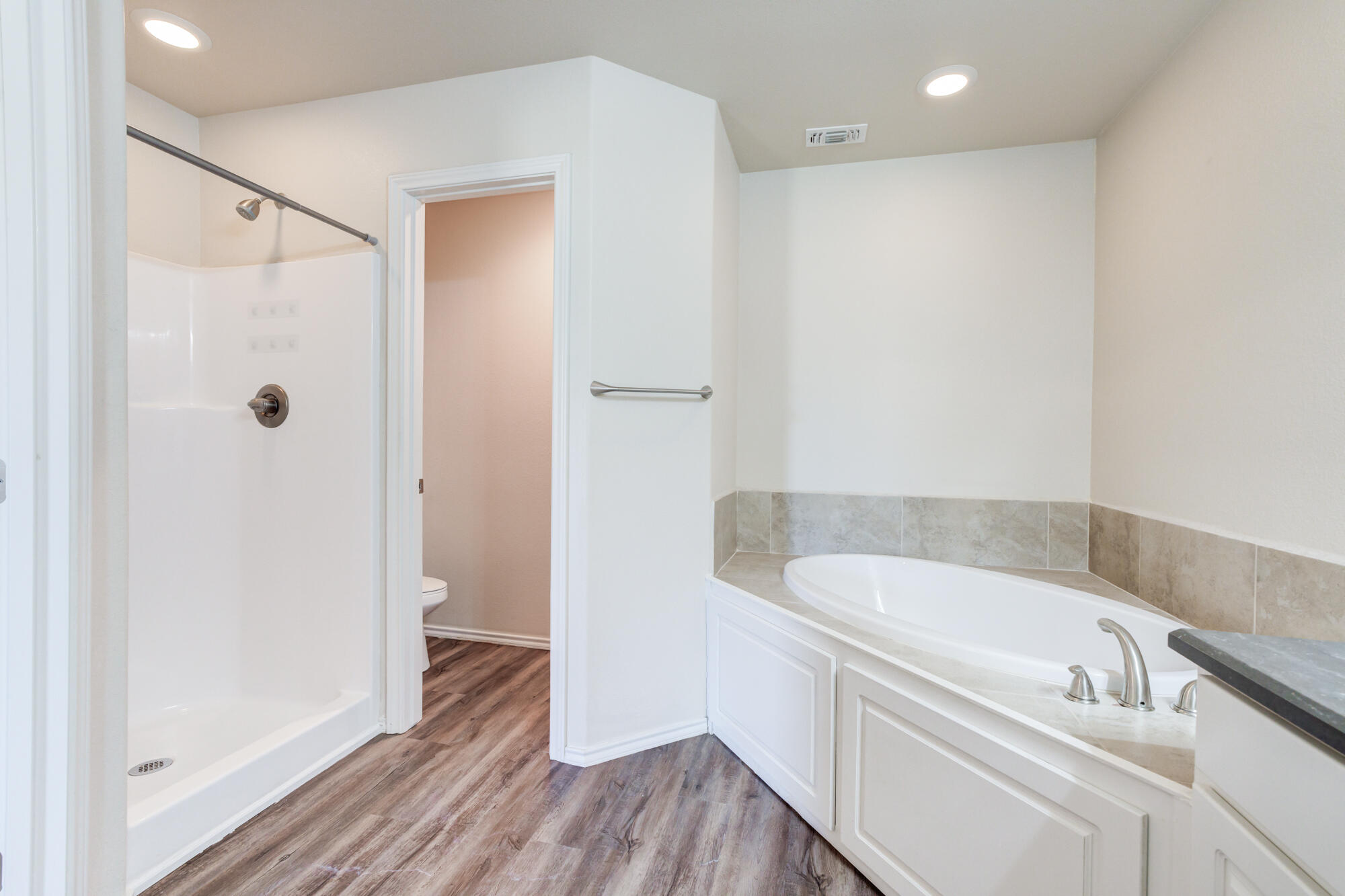 7518 87th Street Lubbock, TX 79424 - Photo 32 of 36 a bathroom with a bathtub and a sink