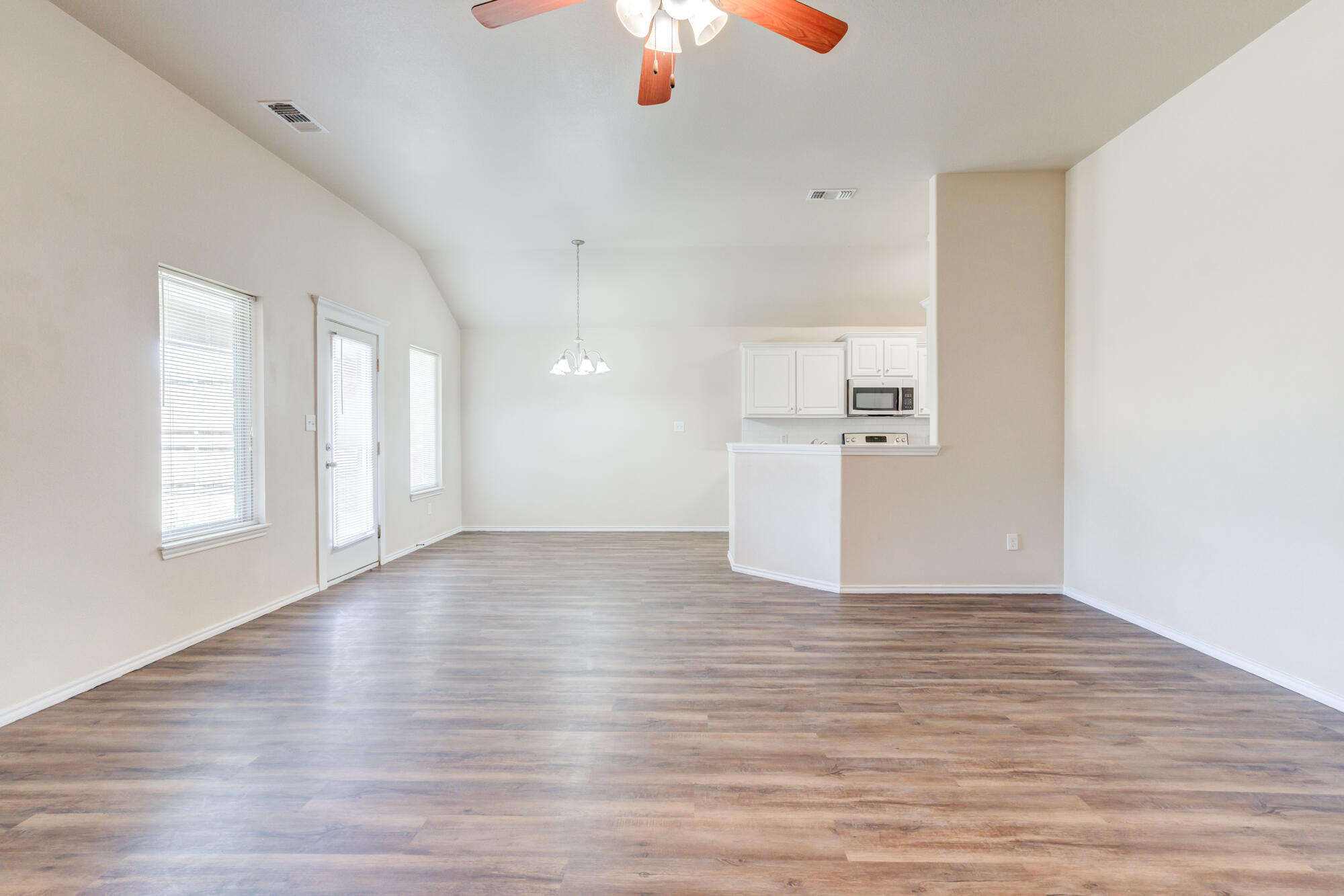 7518 87th Street Lubbock, TX 79424 - Photo 6 of 36 a view of empty room with wooden floor and window