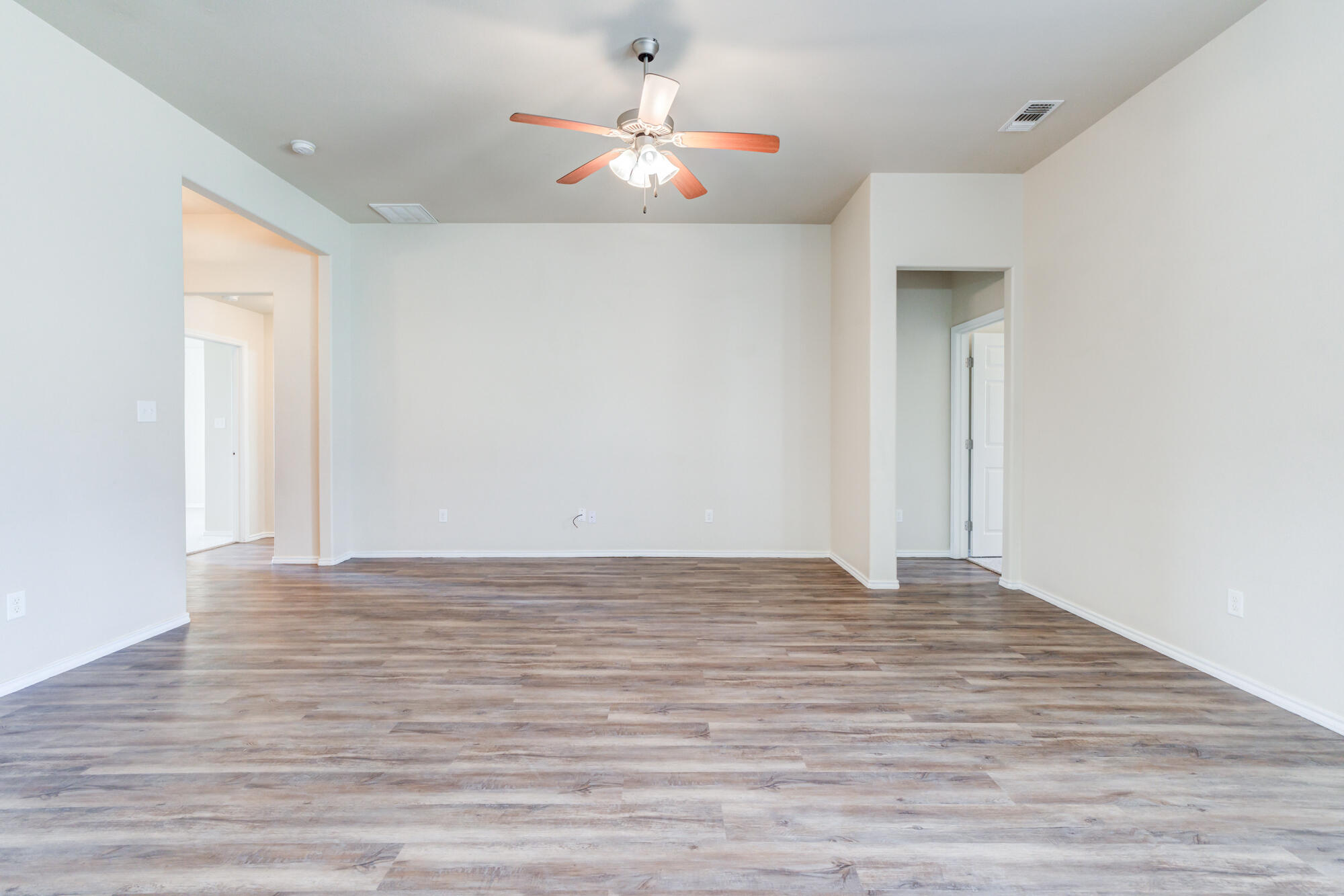 7518 87th Street Lubbock, TX 79424 - Photo 10 of 36 a view of an empty room with wooden floor
