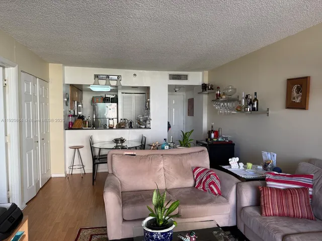 a living room with furniture a couch and a dining table