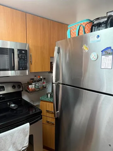 a kitchen with a refrigerator and a stove