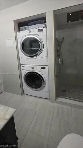 a large kitchen with kitchen island a sink stainless steel appliances and a counter top space