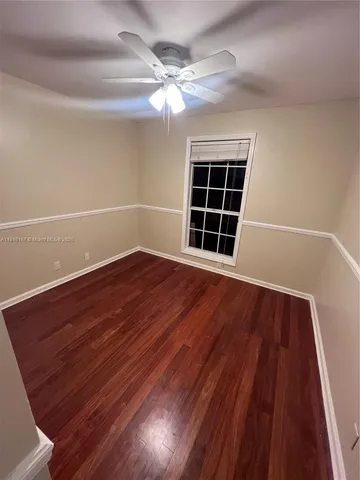 a view of an empty room with a fireplace and a window