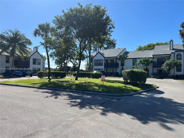 a front view of a house with a yard and outdoor seating