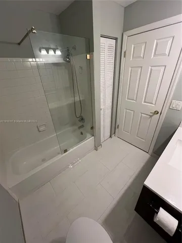 a kitchen with a sink a counter space and cabinets