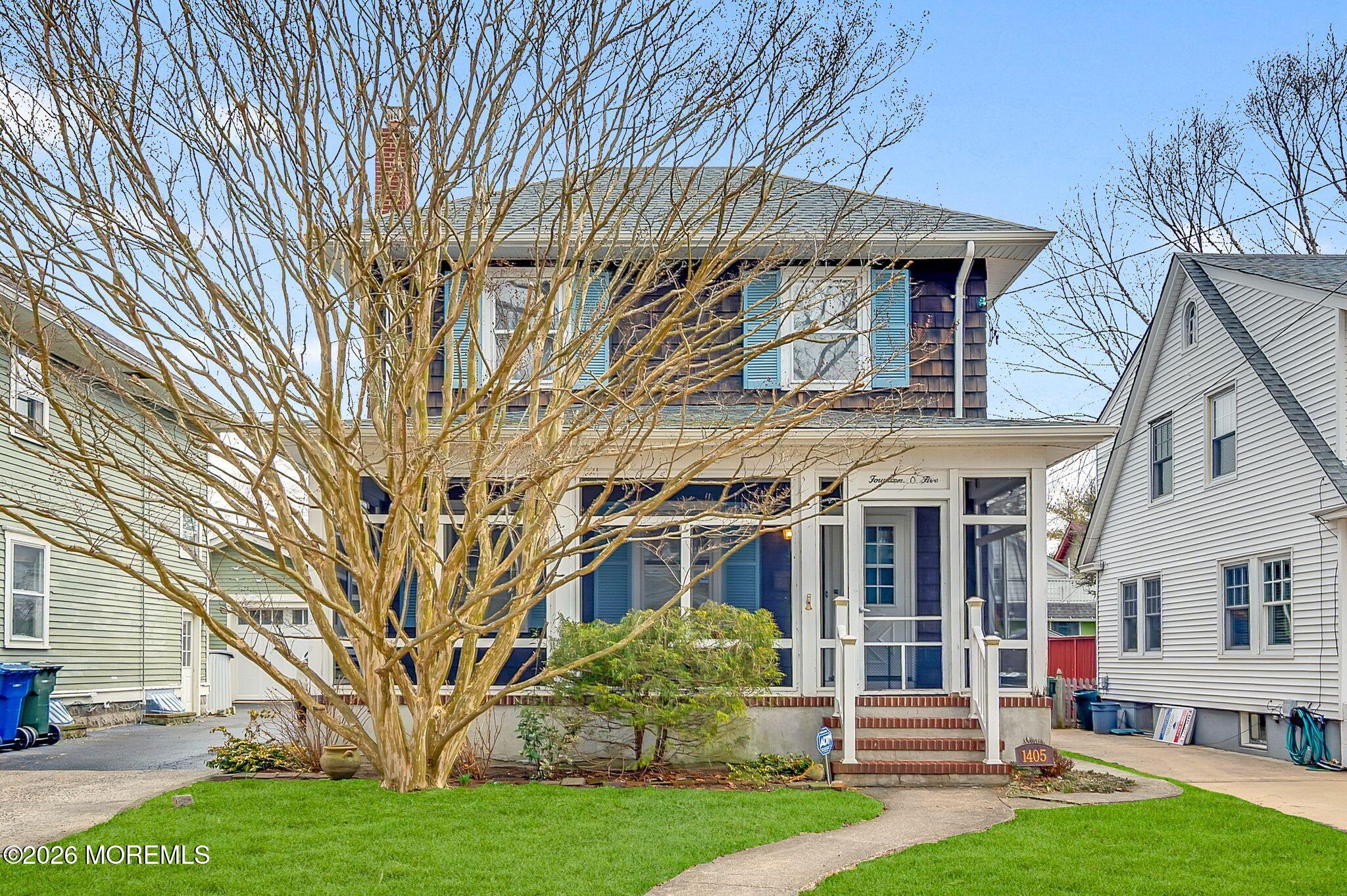 1405 Wanamassa Road Asbury Park, NJ 07712 - Photo 1 of 42 a view of a white house with a big yard and large trees