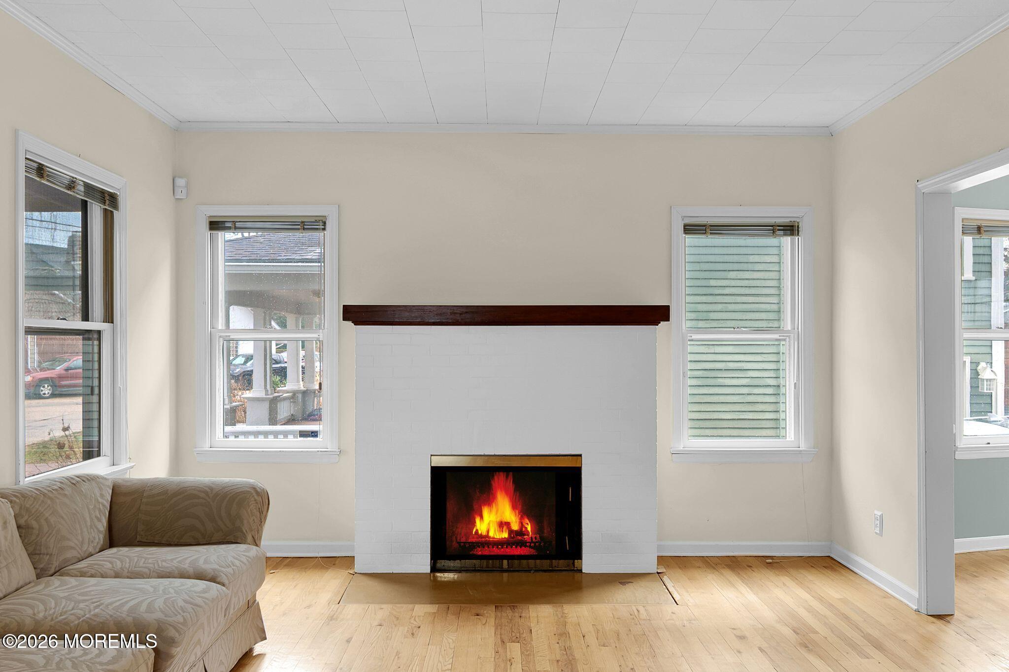 1405 Wanamassa Road Asbury Park, NJ 07712 - Photo 11 of 42 a living room with furniture window and fireplace