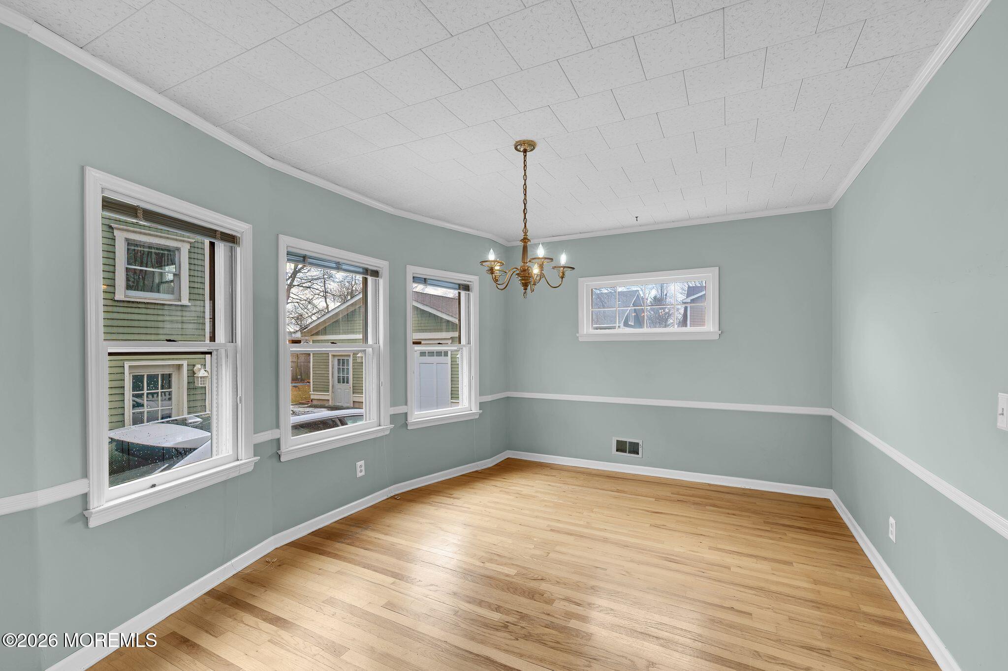 1405 Wanamassa Road Asbury Park, NJ 07712 - Photo 12 of 42 a view of empty room with wooden floor and fan