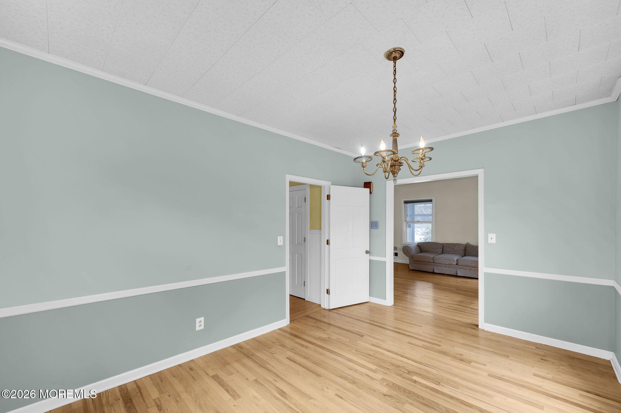 1405 Wanamassa Road Asbury Park, NJ 07712 - Photo 13 of 42 a view of a room with wooden floor and ceiling fan