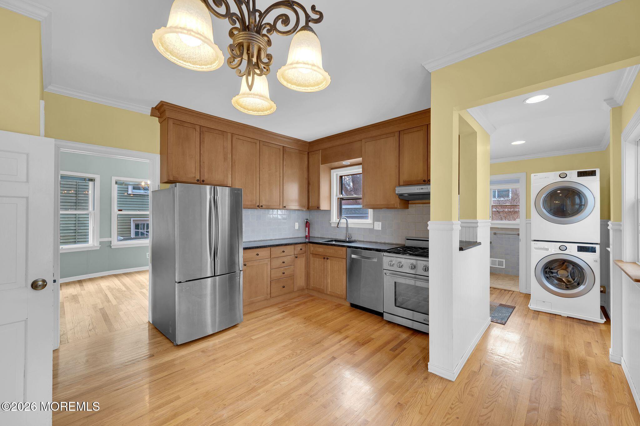 1405 Wanamassa Road Asbury Park, NJ 07712 - Photo 14 of 42 a kitchen with stainless steel appliances granite countertop a refrigerator a stove and a wooden floors