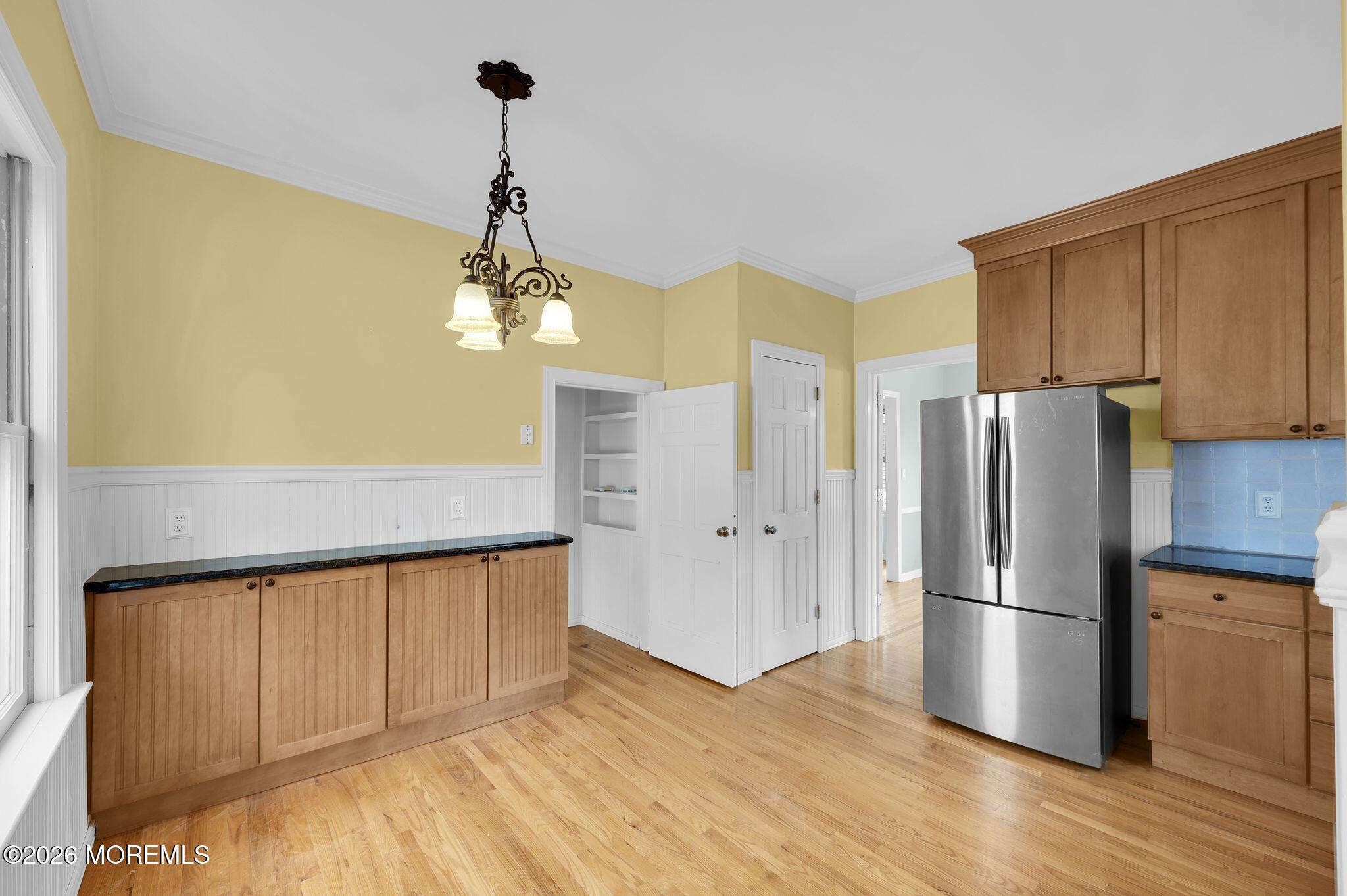 1405 Wanamassa Road Asbury Park, NJ 07712 - Photo 15 of 42 a kitchen with stainless steel appliances granite countertop a refrigerator a stove and a wooden floors