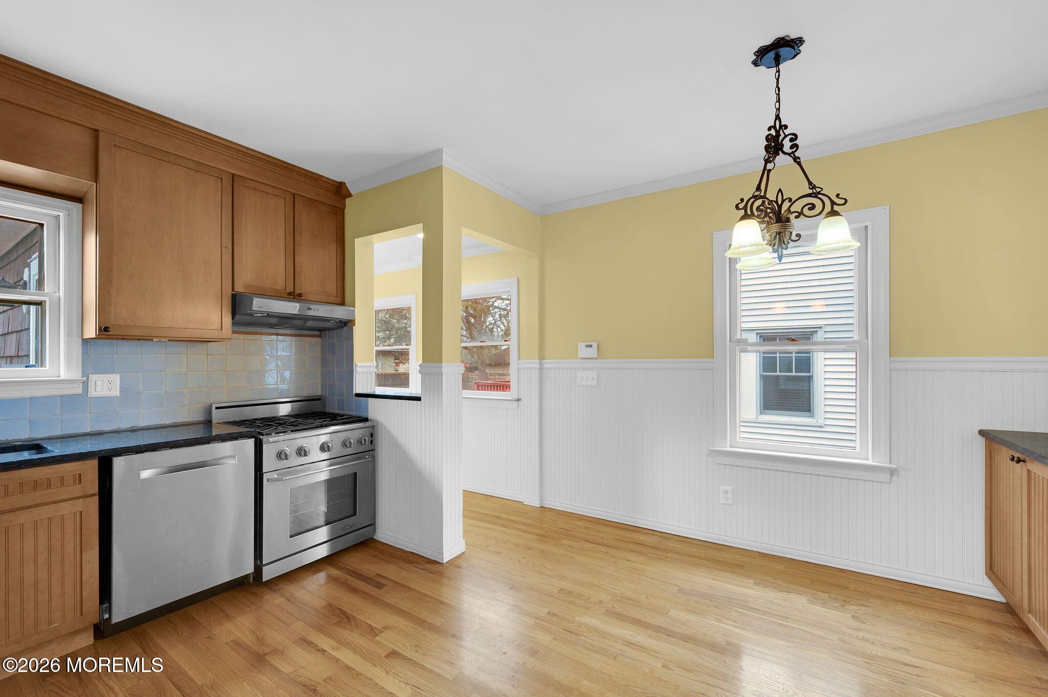 1405 Wanamassa Road Asbury Park, NJ 07712 - Photo 16 of 42 a kitchen with stainless steel appliances granite countertop a stove a sink and white cabinets