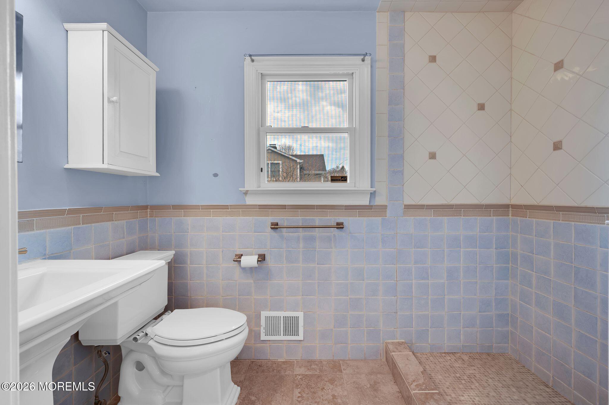 1405 Wanamassa Road Asbury Park, NJ 07712 - Photo 18 of 42 a bathroom with a toilet sink and window