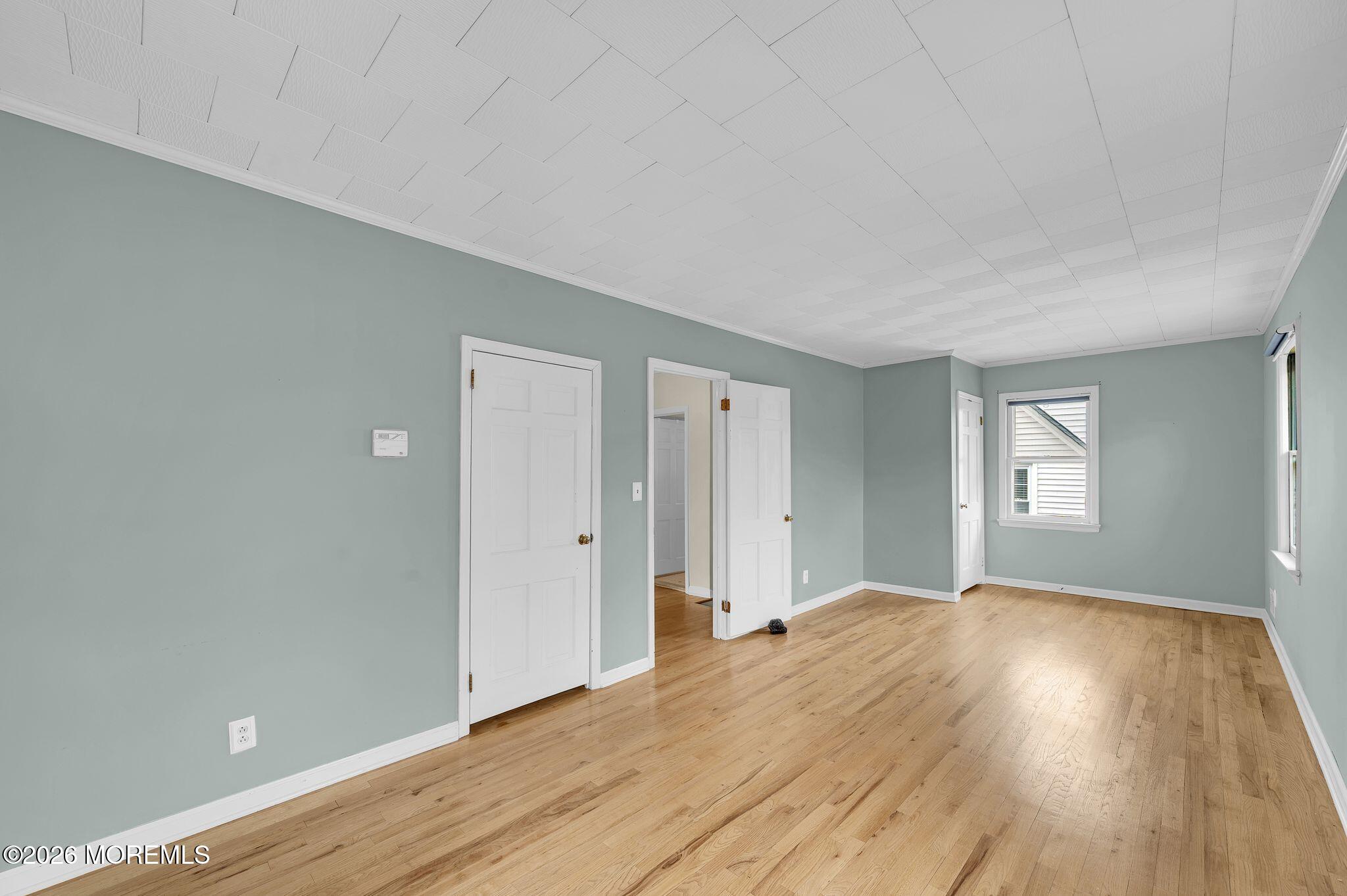 1405 Wanamassa Road Asbury Park, NJ 07712 - Photo 19 of 42 a view of an empty room with wooden floor and a window