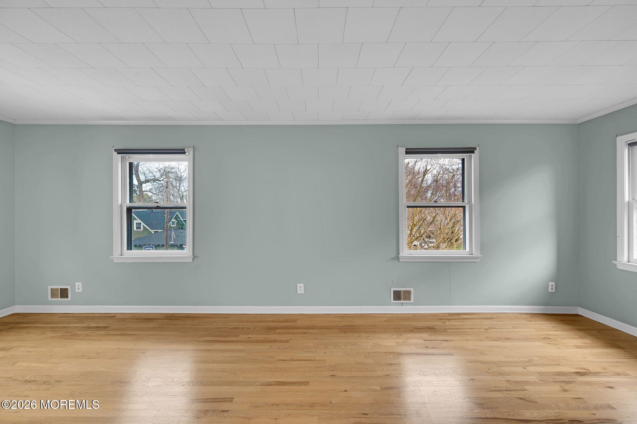 1405 Wanamassa Road Asbury Park, NJ 07712 - Photo 20 of 42 a view of an empty room with window and wooden floor