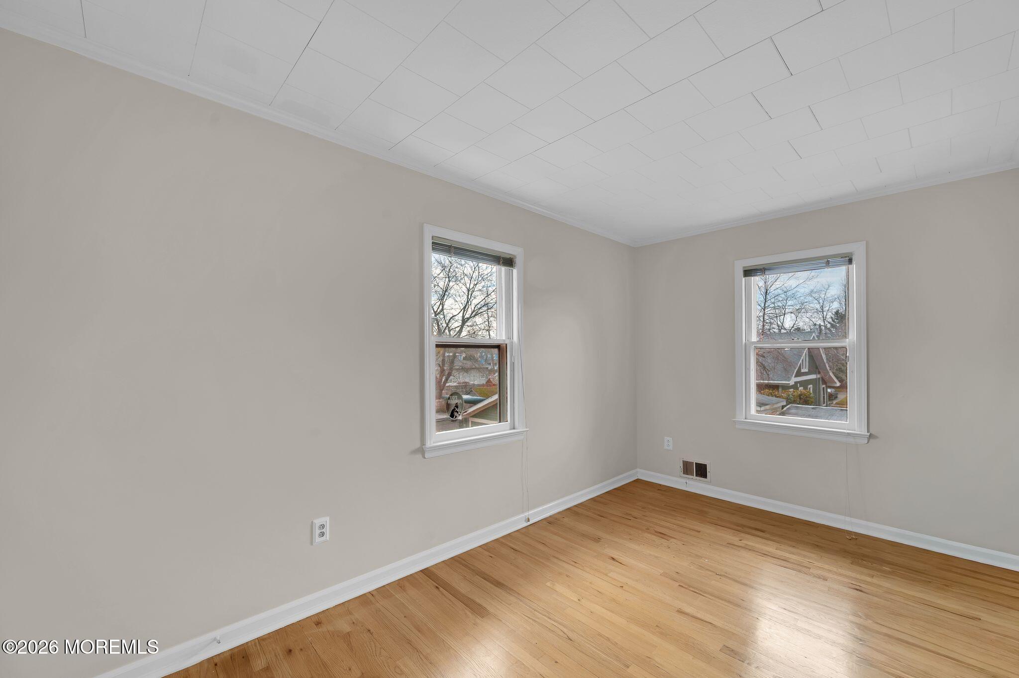 1405 Wanamassa Road Asbury Park, NJ 07712 - Photo 21 of 42 a view of empty room with wooden floor and fan