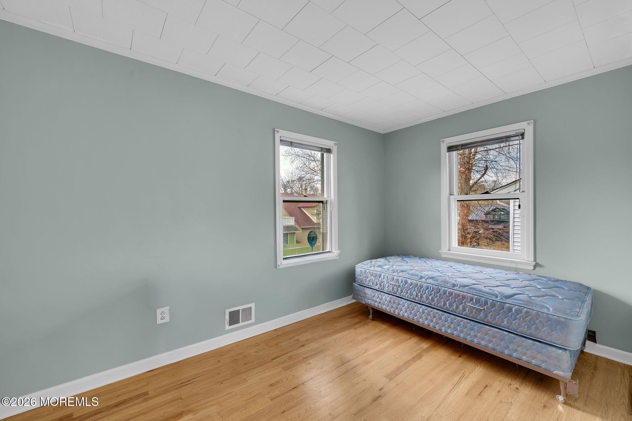 1405 Wanamassa Road Asbury Park, NJ 07712 - Photo 22 of 42 a living room with a bed furniture and a window