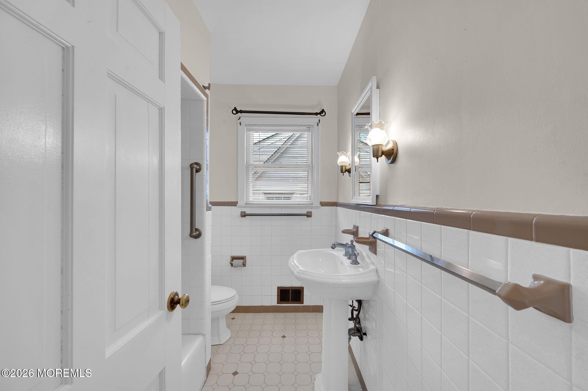 1405 Wanamassa Road Asbury Park, NJ 07712 - Photo 23 of 42 a bathroom with a sink and a mirror