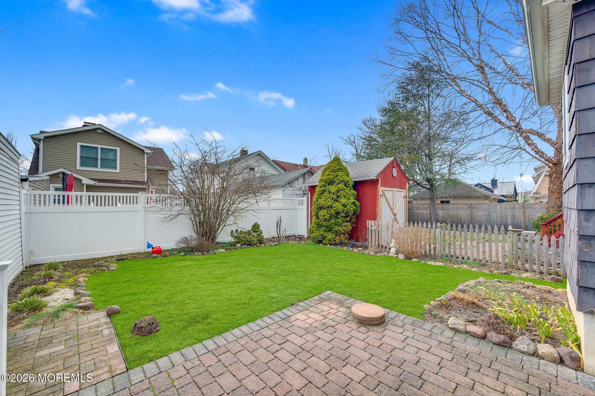 1405 Wanamassa Road Asbury Park, NJ 07712 - Photo 26 of 42 a view of a house with a yard and a garden