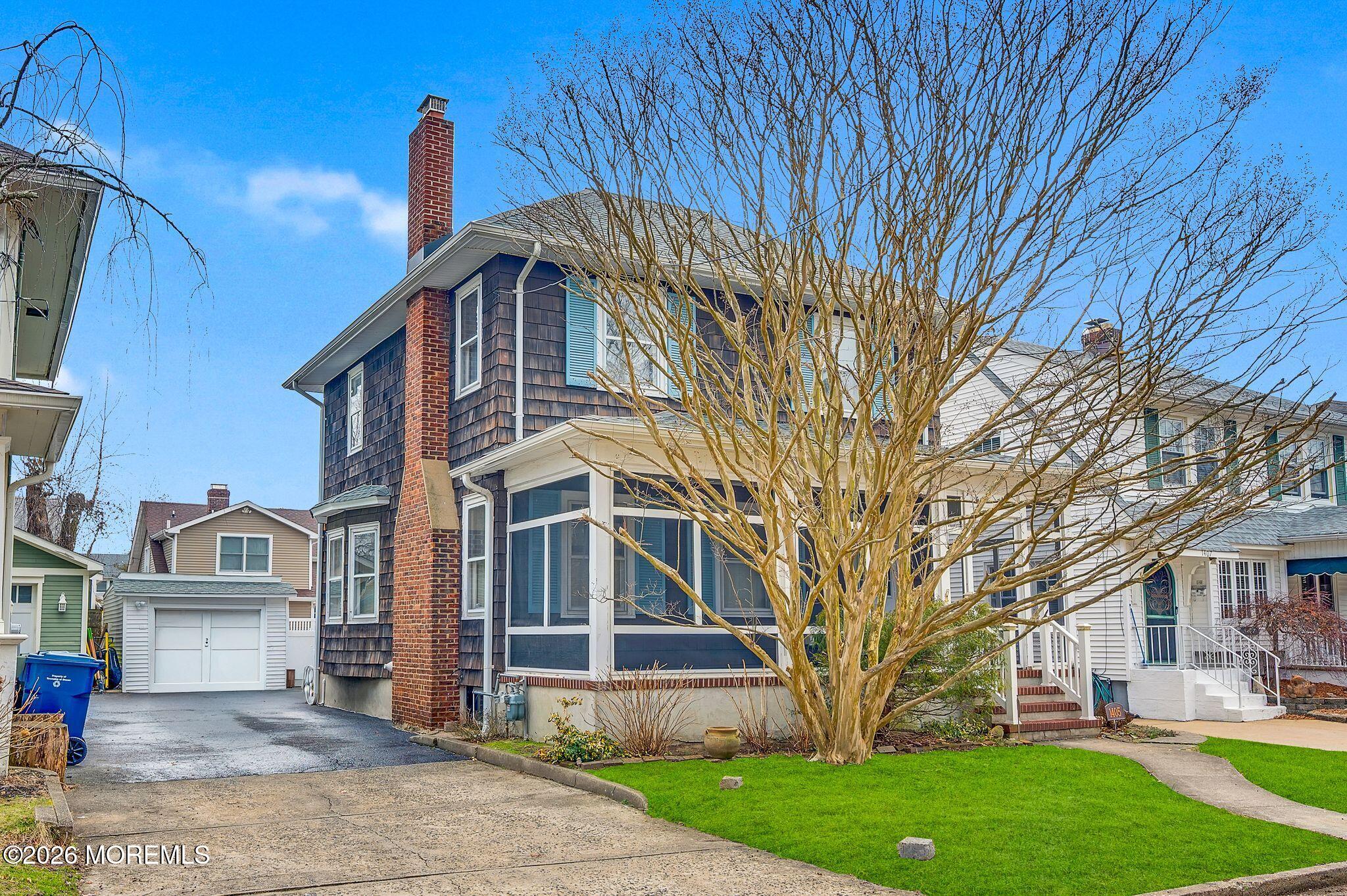 1405 Wanamassa Road Asbury Park, NJ 07712 - Photo 3 of 42 a front view of a house with a garden